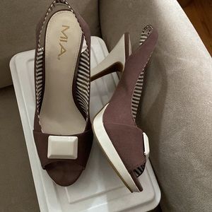 Brown with white accent button heels. Made by Mia.